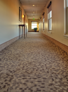 A long hallway featuring a modern patterned carpet tile installation by Direct Solutions Flooring in Baltimore, MD.