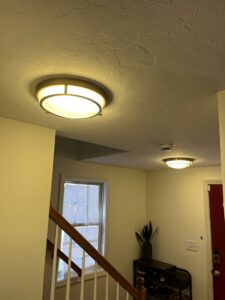 Two modern ceiling light fixtures installed in a residential hallway by Richard Sullivan Licensed Electrician in Brockton, MA.