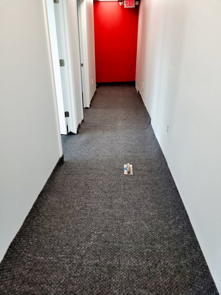 A residential hallway featuring a new grey carpet installation by VA Carpet Connection LLC in Chesapeake, VA.