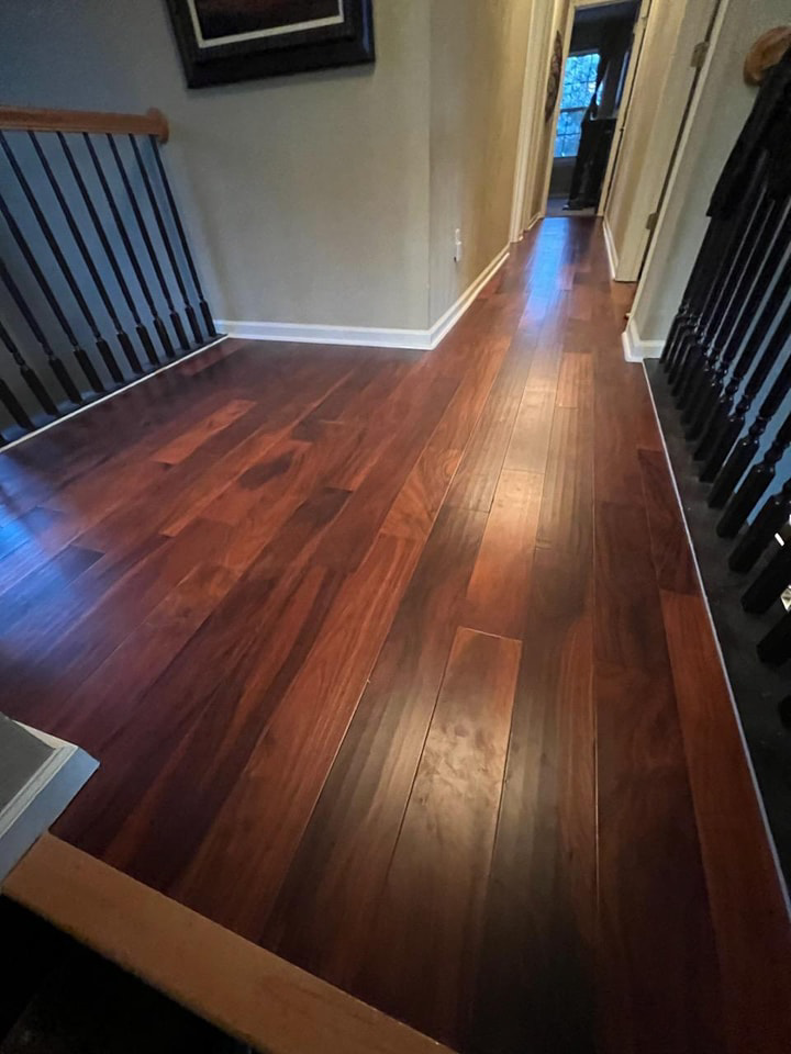 A residential hallway showcasing a beautiful new hardwood flooring installation by VA Carpet Connection LLC in Chesapeake, VA.