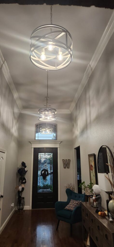 Two stylish light fixtures illuminating a hallway, installed professionally by Mister Sparky NWA in Springdale, AR.