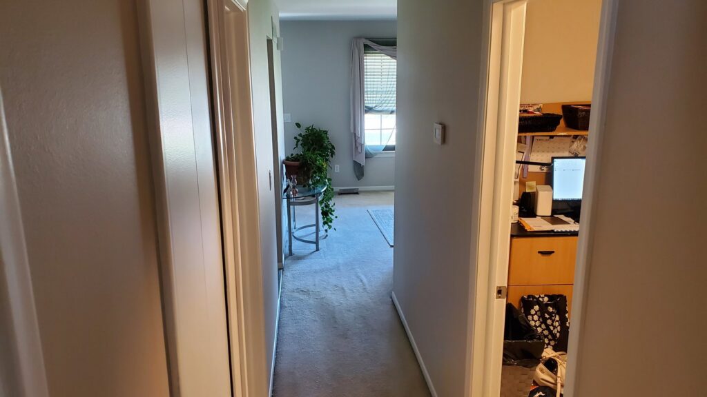 Professional installation of light grey carpet in a hallway by Son Shine Floor Covering LTD, a carpet contractor in Warren, MI.
