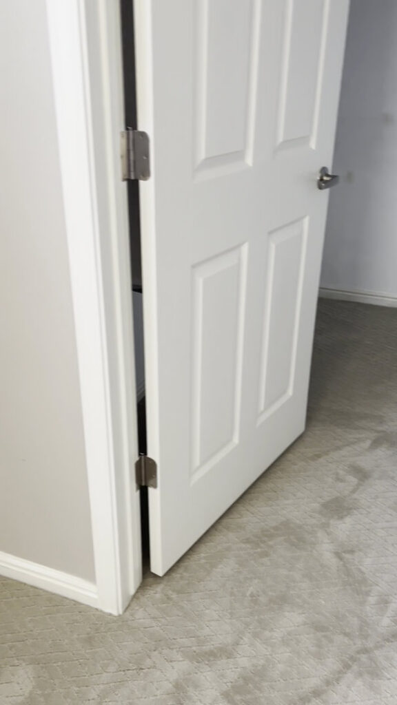 An interior hallway with newly installed light grey patterned carpet by AFS Flooring West Jordan in West Jordan, UT.
