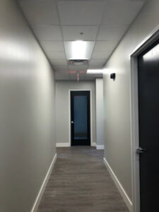 Hallway lighting installation with fluorescent fixtures by Empower Electric, LLC in Nashville, TN.