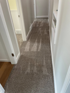 A hallway with a new grey carpet installation by CDK Flooring, LLC in Sheboygan, WI.