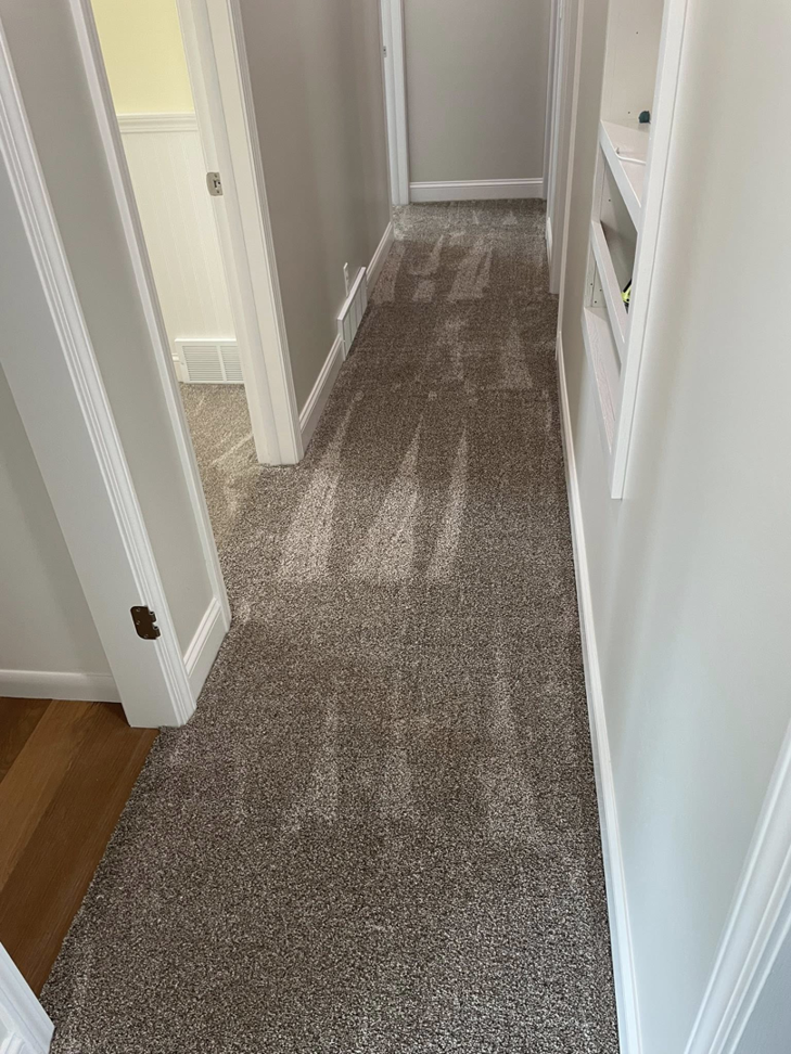 A hallway with a new grey carpet installation by CDK Flooring, LLC in Sheboygan, WI.