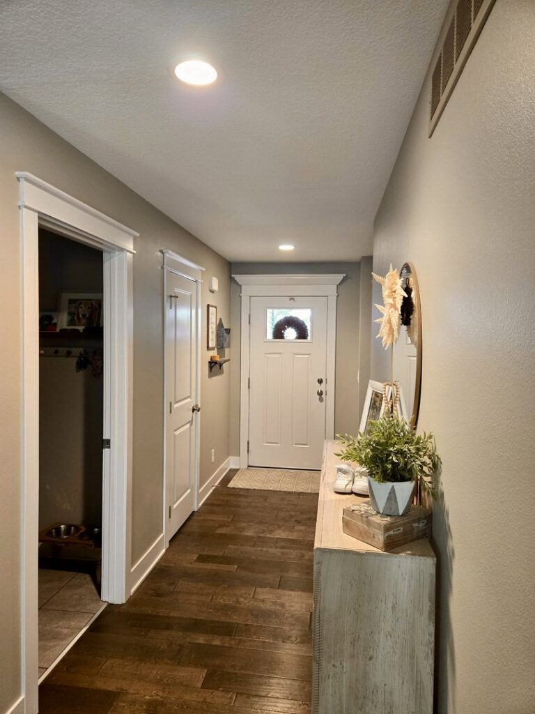 A well-lit hallway featuring modern recessed lighting installed by Woodford Power & Light Co. in Ankeny, IA.
