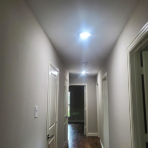 A brightly lit hallway featuring new recessed lighting installed by Triple JS & B Electric Inc. in Dallas, TX