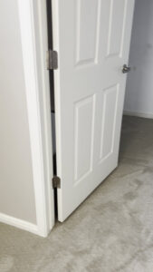 A view through a doorway into a room with newly installed light grey carpet by AFS Flooring West Jordan, UT