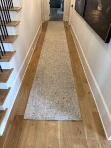 A patterned runner rug extending down a hallway, installed by Advanced Cleaning Systems in Atlanta, GA.
