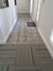 A clean hallway featuring a combination of carpet tiles and ceramic flooring, showcasing work by All-Star Carpet Cleaning in Dallas, TX.