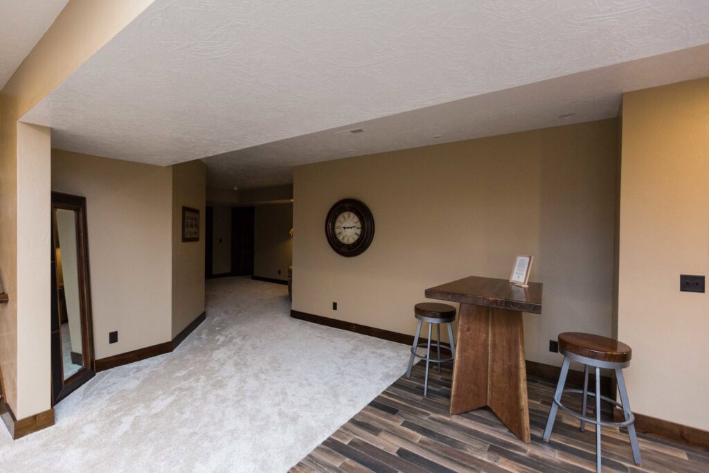 A residential hallway showcasing new light-colored carpet installed by Floors & More Abbey Flooring in Great Falls, MT.