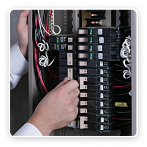 A hand adjusting a circuit breaker inside an electrical panel, a common task performed by Your Gilbert Electrician in Gilbert, AZ.