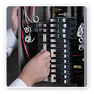 A hand adjusting a circuit breaker inside an electrical panel, a common task performed by Your Gilbert Electrician in Gilbert, AZ.