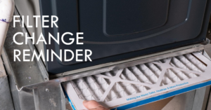 A hand changing a furnace air filter, a common HVAC maintenance task by Select Heating & Air, Inc in Lincoln, NE.