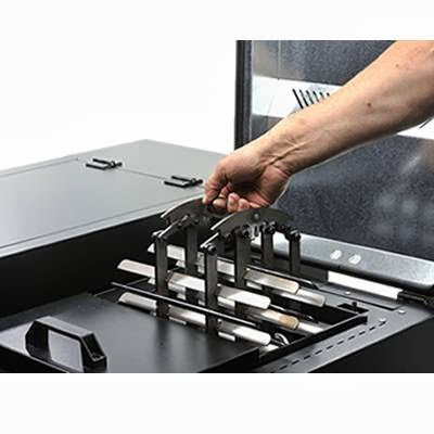 A hand operating a cleaning mechanism inside a boiler, demonstrating maintenance features of Kedel Boilers in Portland, ME.