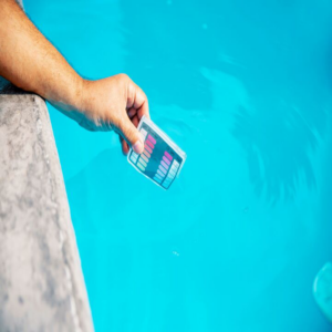 A hand testing pool water with a chemical test kit, a service provided by Bryan Simpson in Services Available In.