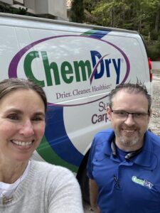 A happy customer with a Chem-Dry technician in front of a branded van from Mountainview Chem-Dry in Birmingham, AL.