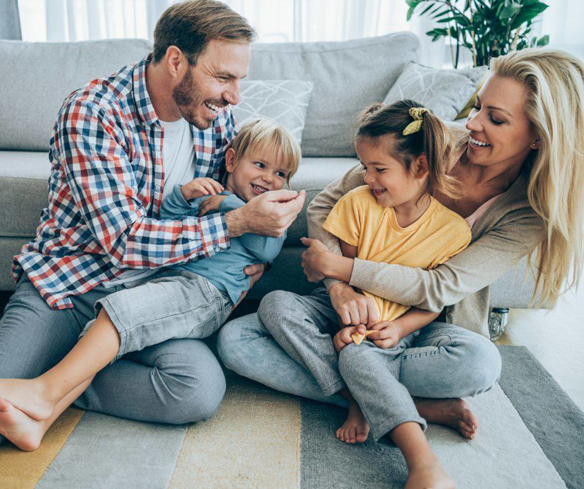 A happy family enjoying their soft, comfortable carpet installed by Faith and Grace Flooring in Murfreesboro, TN.