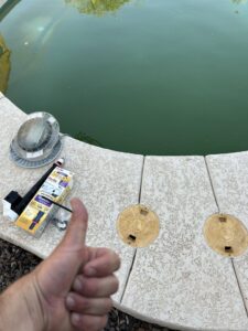 A thumbs-up next to a newly installed Hayward OmniPL pool control panel by Classic Pool Service in Surprise, AZ
