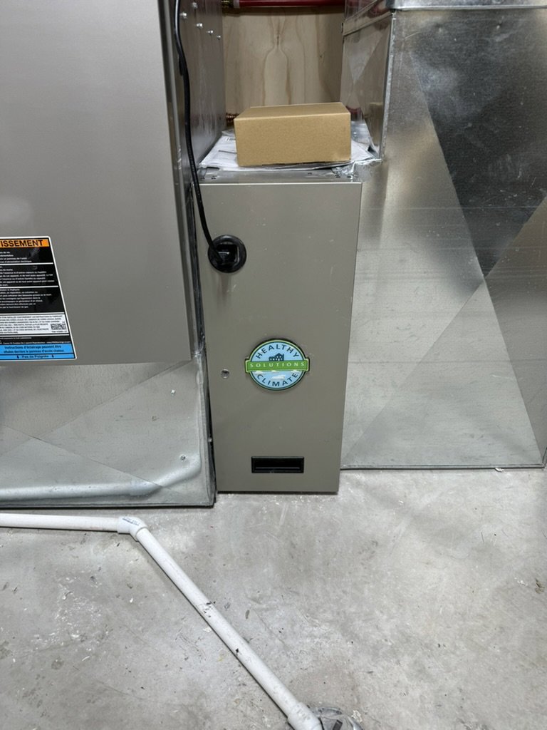 A Healthy Climate air purification unit installed alongside a furnace by Dischler Heating-Cooling & Fireplaces in Prairie du Sac, WI.