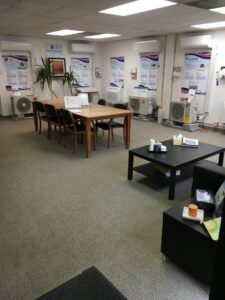 A showroom displaying various indoor and outdoor heat pump units at The Heat Pump Store in Portland, OR.