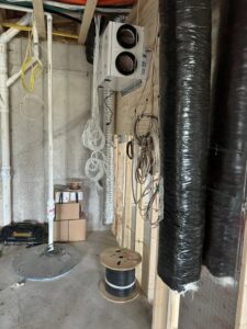 A heat recovery ventilator (HRV) unit with associated ductwork and wiring installed by Dischler Heating-Cooling & Fireplaces in Prairie du Sac, WI.