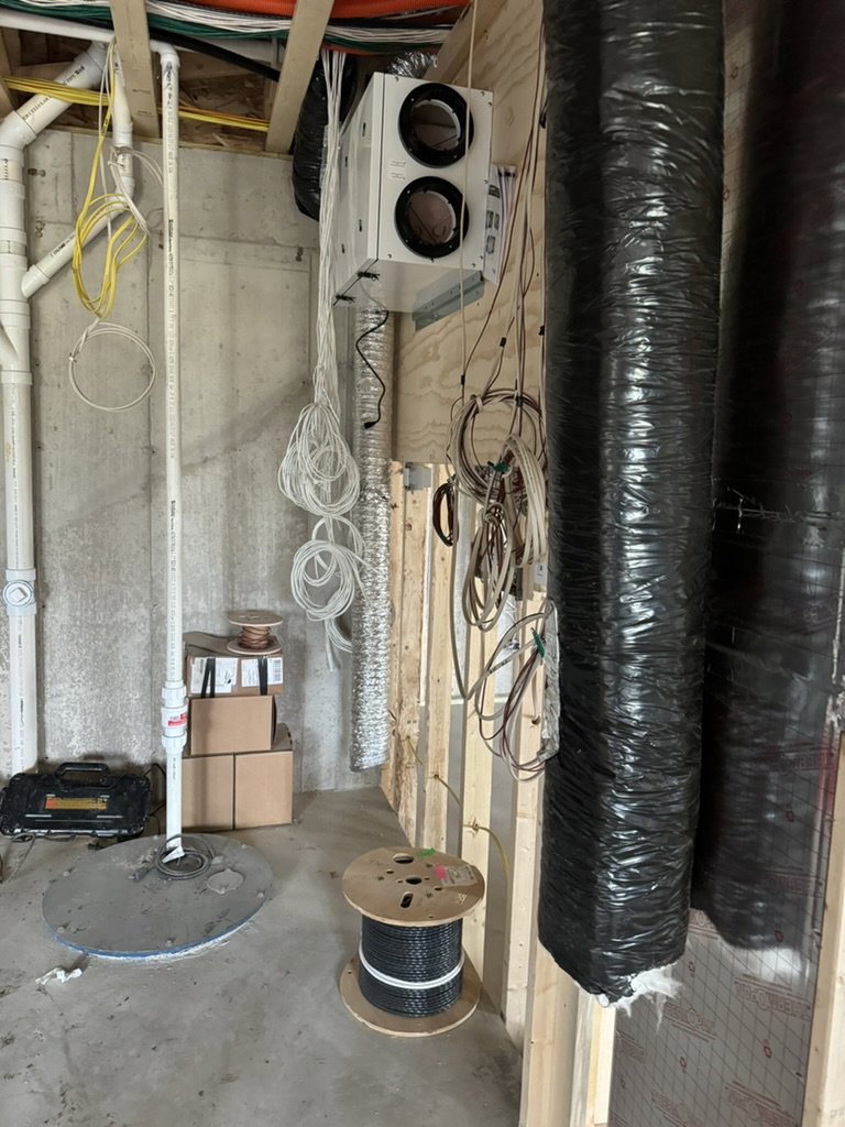 A heat recovery ventilator (HRV) unit with associated ductwork and wiring installed by Dischler Heating-Cooling & Fireplaces in Prairie du Sac, WI.