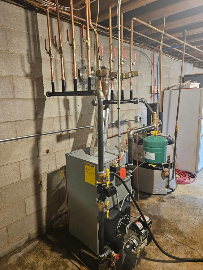 Newly installed heating boiler system with copper piping in a basement by NewEra Mechanical LLC in New Britain, CT