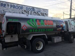 A heating oil delivery truck with the L&SON Heat AC Tech logo in Yonkers, NY.