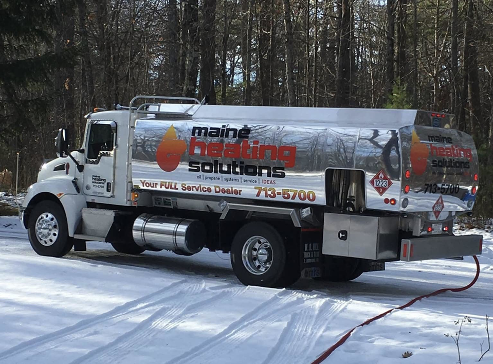 A Maine Heating Solutions heating oil delivery truck parked in the snow, providing service in South Portland, ME.