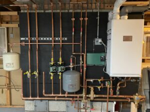 A detailed view of a heating system installation with new copper pipes by Tony Marzano Plumbing & Heating LLC in Hartford, CT.