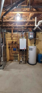 A comprehensive heating system installation with boiler, water heater, and extensive piping by Crome Mechanical Inc. in Cedar Springs, MI
