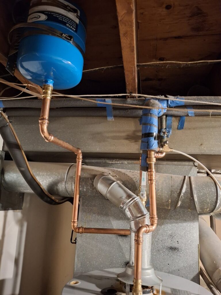 Copper piping and an expansion tank installed as part of a heating system by A.B. May Heating, A/C, Plumbing & Electrical in Kansas City, MO.