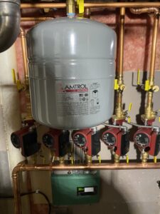 Close-up of heating system pumps and an expansion tank installed by Heritage Home Service in Worcester, MA