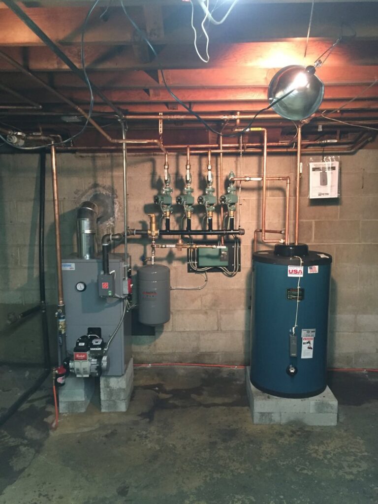 A complete heating system with boiler and blue hot water tank installed by JLP Heating & Cooling in Norwalk, CT