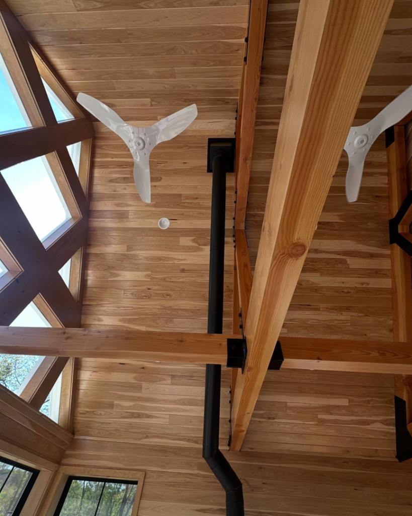 Heating and ventilation system components, including a vent pipe and ceiling fans, installed by Greer Enterprises in Raymond, NH.