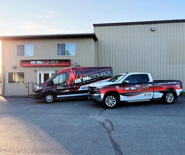 HeatSource Mechanical service van and truck parked outside the business office in Wasilla, AK.