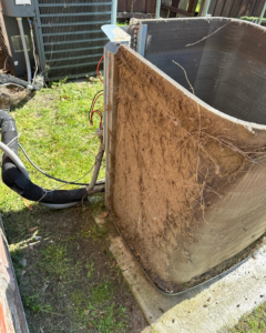 Heavily clogged outdoor AC unit coils before cleaning by CLM Mechanical in Dallas, TX
