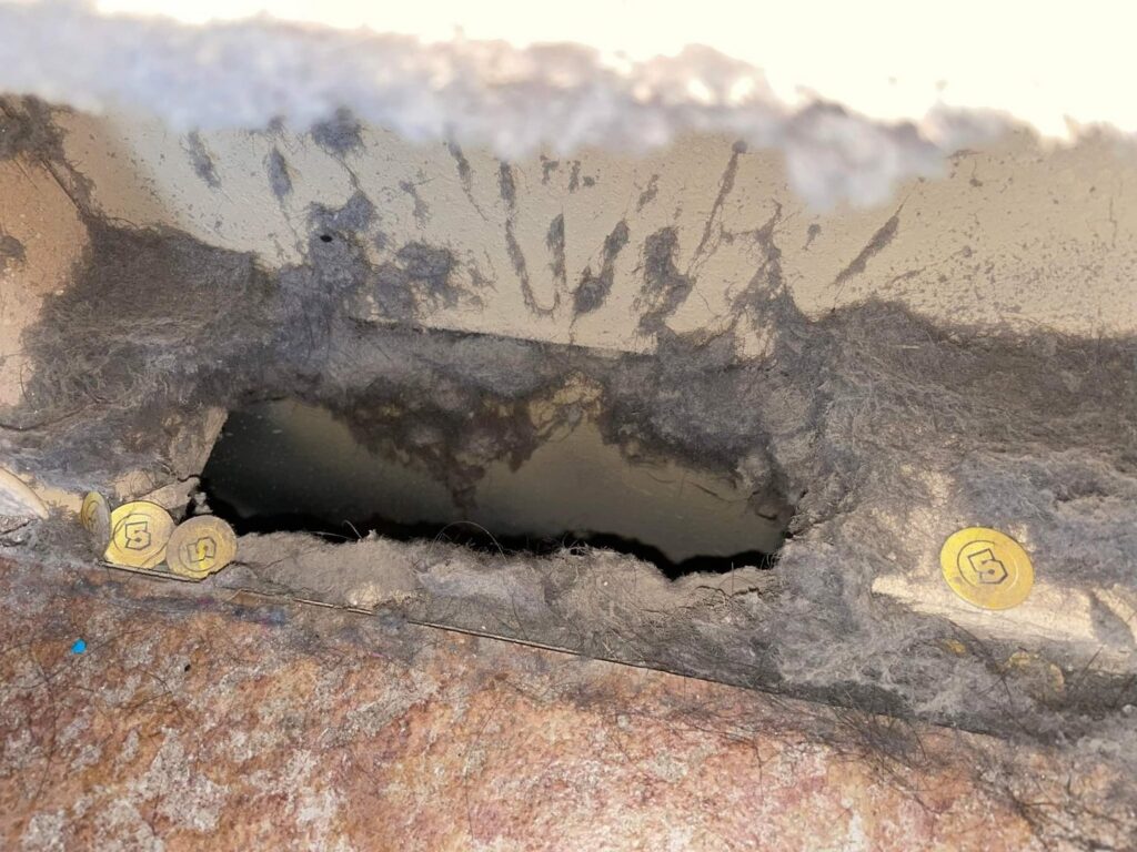 A heavily dusty HVAC air return vent opening, showing significant buildup that requires cleaning by Aero Brush Duct Cleaning in Billings, MT.
