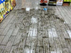 A heavily soiled tile floor in a commercial setting before cleaning by Great Day Carpet & Tile Cleaning LLC Desoto in Olive Branch, MS.