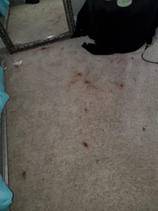 A heavily stained carpet in a bedroom, ready for professional cleaning by T&P Carpet Care in Charlotte, NC.