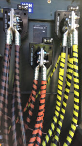 Heavy-duty electrical cable connections with striped insulation inside an electrical enclosure by E & E Electric in Post Falls, ID.