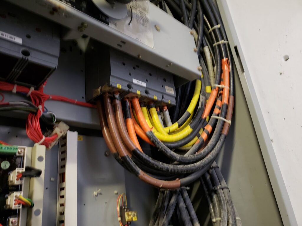 Heavy electrical wiring and cables inside a commercial panel, expertly handled by Electricians On Call in Fort Lauderdale, FL.