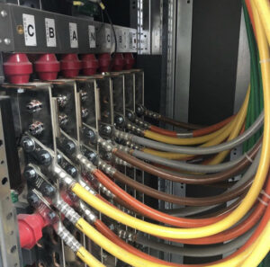 Close-up of heavy-gauge electrical cables connected to busbars inside a panel by Harbour Electric in Wilmington, NC.