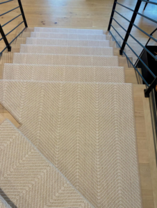 Beautiful herringbone pattern carpet installed on a residential staircase by Trademark Flooring in West Jordan, UT.