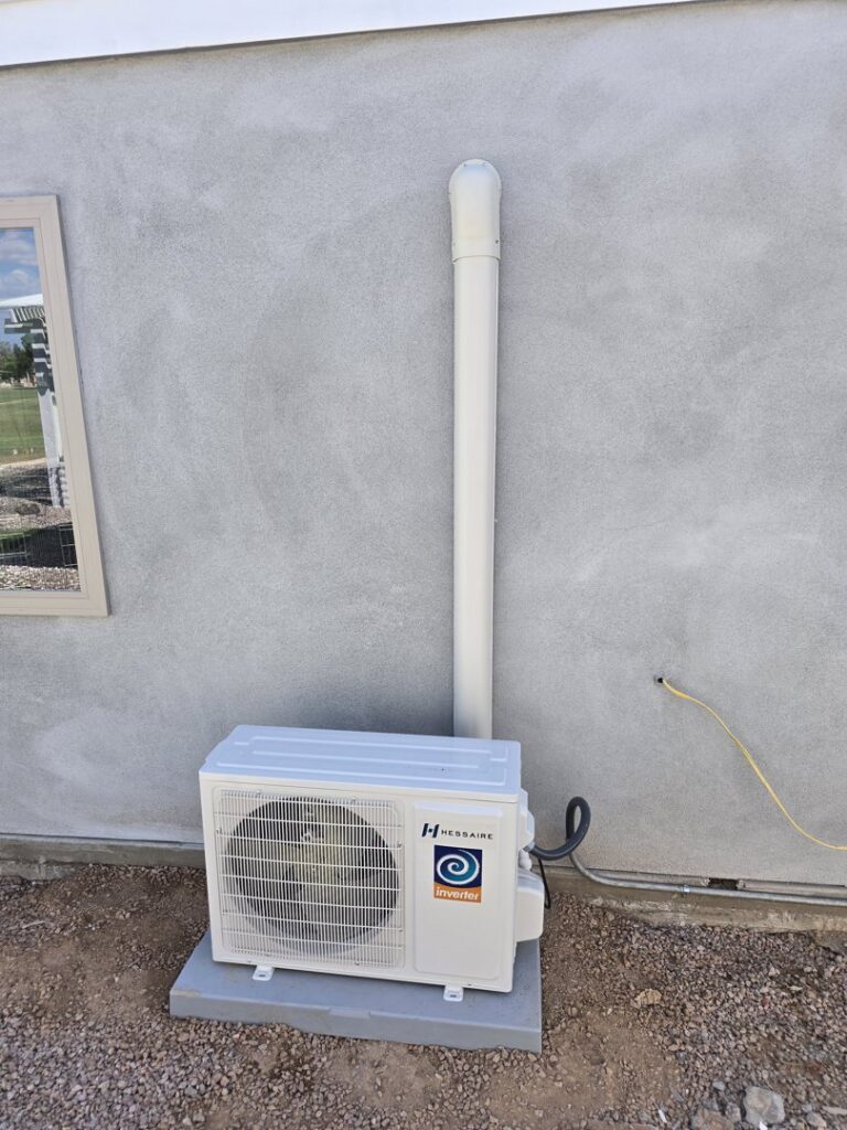 A Hessaire mini-split outdoor unit newly installed on a concrete pad by Quantum Cooling & Heating in Mesa, AZ.