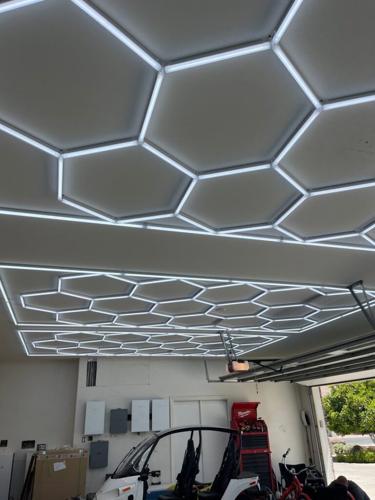 Unique hexagonal LED lighting fixtures installed on a garage ceiling by EV Electric LLC in Mesa, AZ