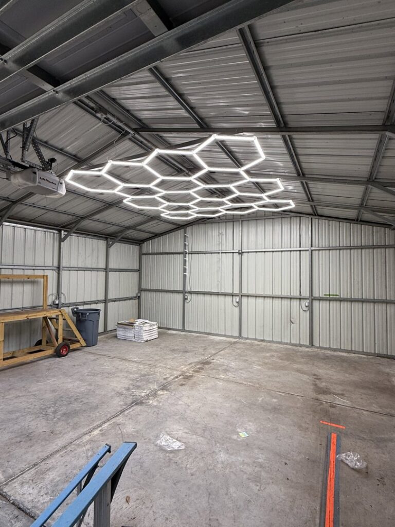 Unique hexagonal LED lighting installed on the ceiling of a large metal building by A Solid Connection Electrical Services in Brandon, FL.