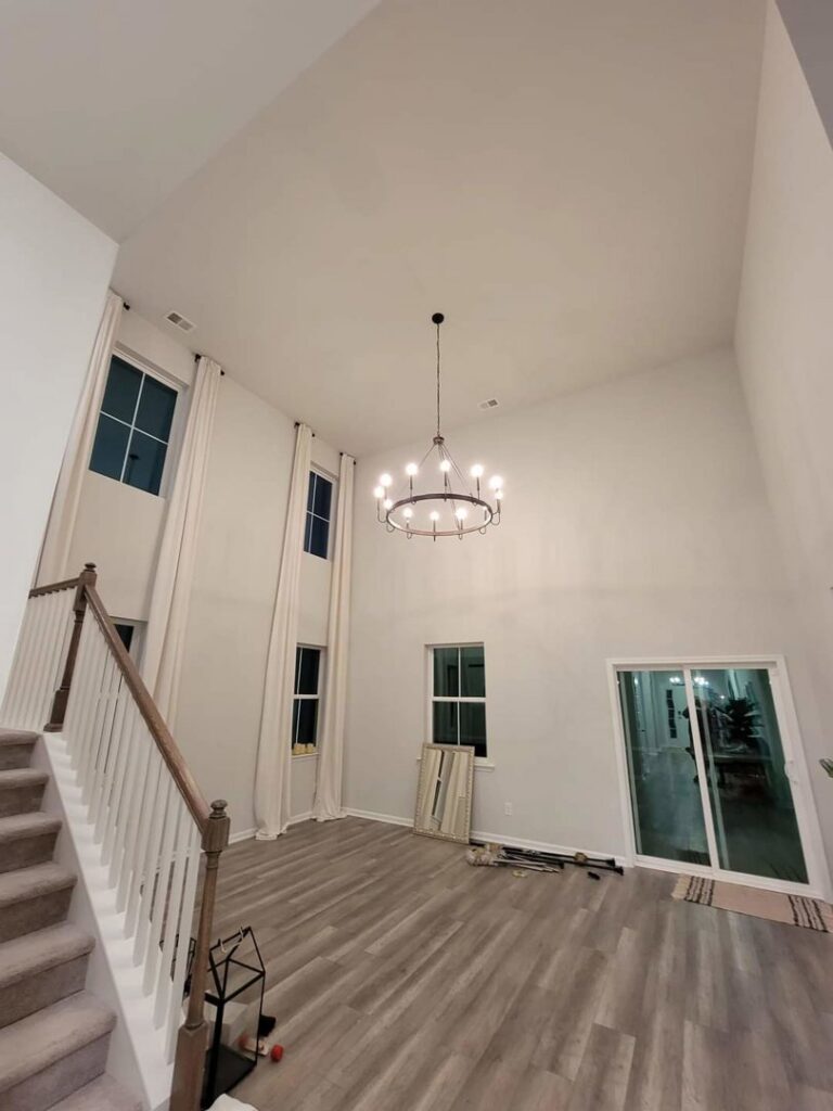 A large chandelier installed in a high-ceiling living room by Lindsey and Son Electric, LLC in Summerville, SC